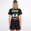 Model back view of black paint splash smiley rave soccer jersey with white X-eyed smiley face over a rainbow paint splash and custom name