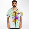 Model wears a rainbow paint-splatter jersey with black piping and bold chest lettering, front view