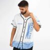Model adjusts white jersey front with FEARLESS lightning lettering and blue hibiscus trim