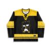 Black and yellow cartoon penguin design with patterned bands, front view of festival hockey jersey