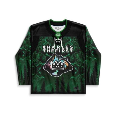 Black Forest misty pine pattern hockey jersey with crown crest and green swirls, front view