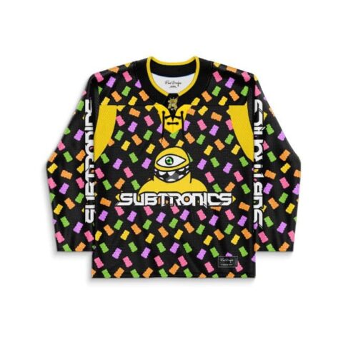 Front view of neon tossed candy pattern with one-eyed alien graphic, studio product setting