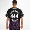 Back view of model wearing purple geometric cube pattern with RIDOIM ANGEL 444 PRINCESS lettering