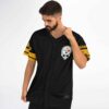 Black-and-gold skull emblem and striped sleeves worn by a model, angled front view