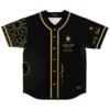 Black-and-gold Moroccan geometric jersey front with sun motifs and Arabic lettering, studio product view