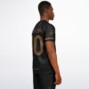 Close-up back view of black rave soccer jersey with gold details