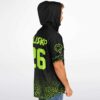 Side view of a man wearing the black rave hooded baseball jersey with neon green accents