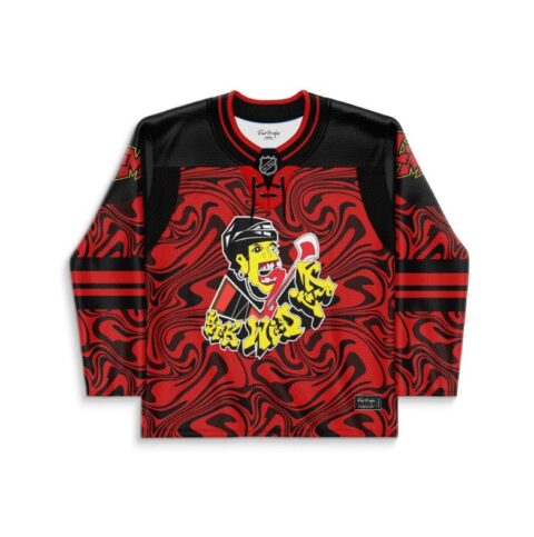 Front view of red-and-black abstract swirl jersey with yellow-faced cartoon hockey player graphic