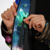 Glowing forest cloak zipper close-up featuring hummingbird, crystal artwork, floral details, and plush lining