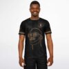 Model wearing black and gold line art rave soccer jersey, model front view