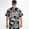 Black and gray camouflage pattern with oversized back lettering, worn by a model from behind