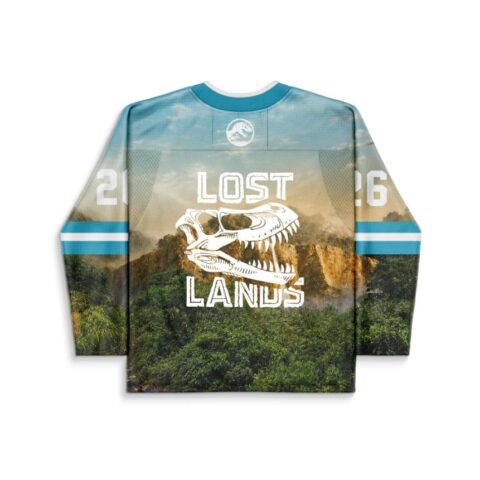 Sky blue dinosaur landscape jersey with white fossil skull graphic and forest backdrop, back view