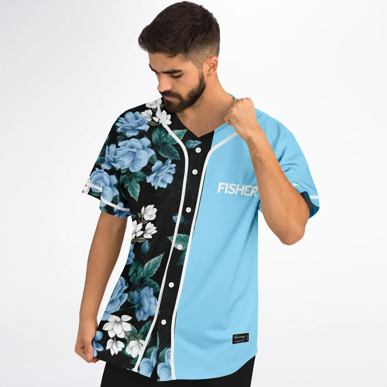 Detail shot of the blue rose and white floral print with green leaves on the black jersey panel