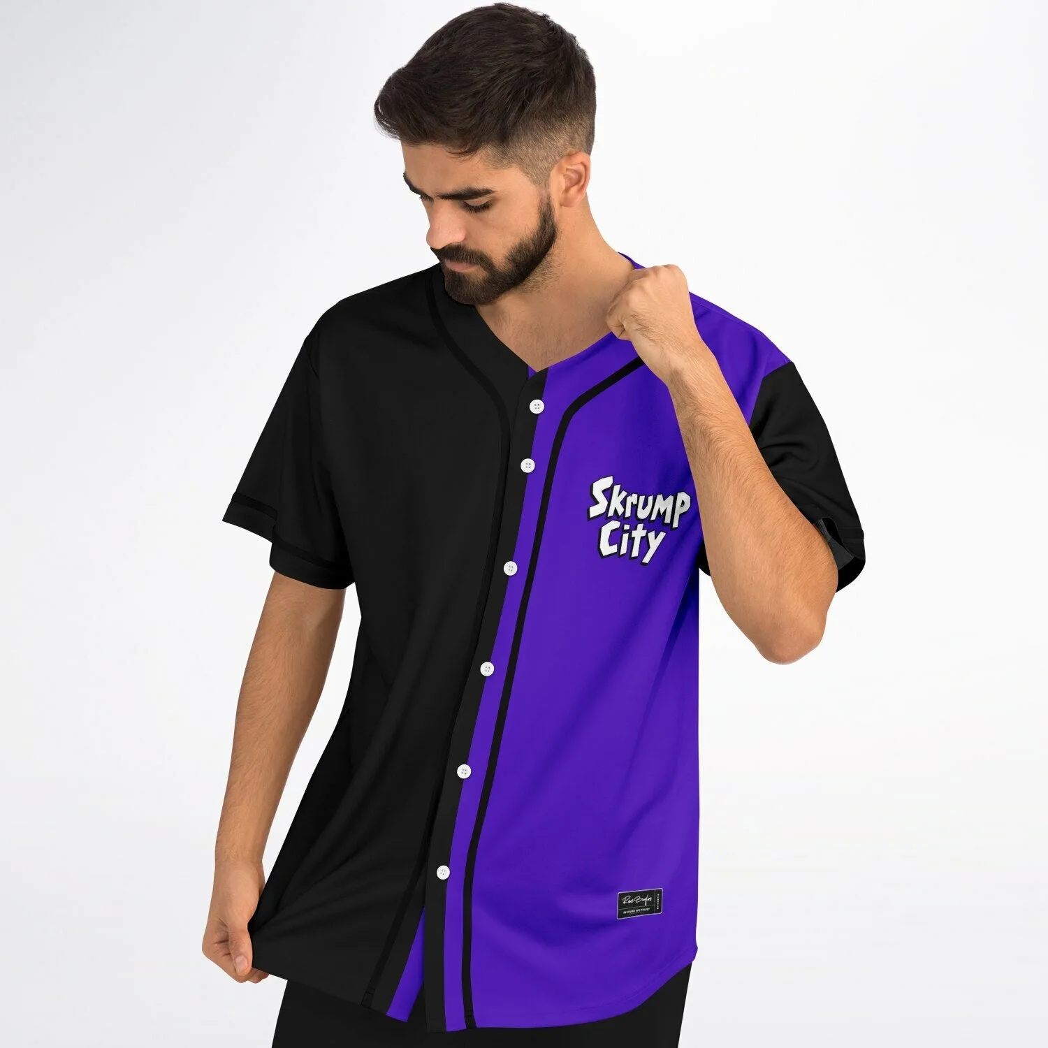 Close-up angle of purple pink and black baseball jersey with abstract geometric shapes and cartoon character print