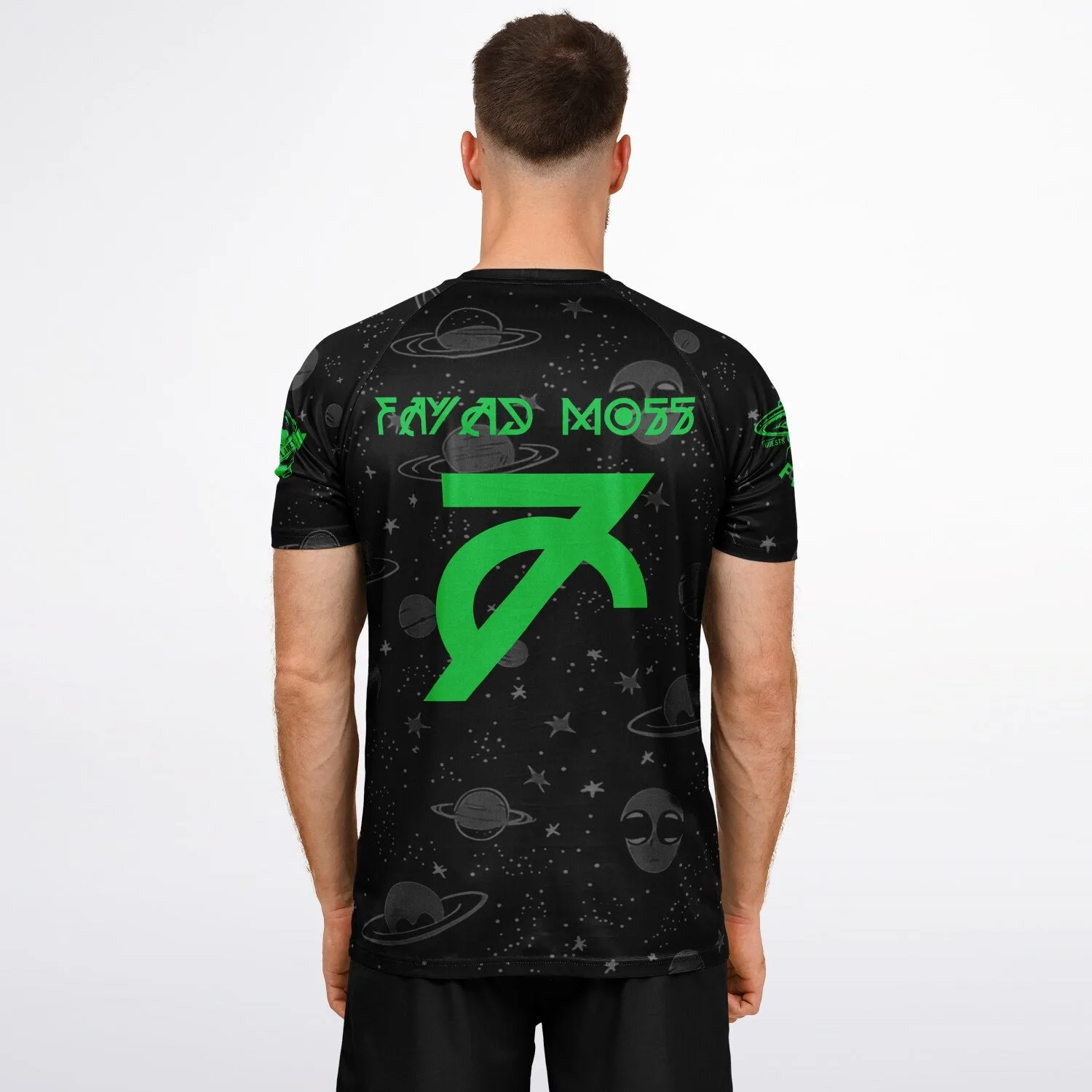 Close-up of sleeve print showing green alien and planet graphic on galaxy jersey