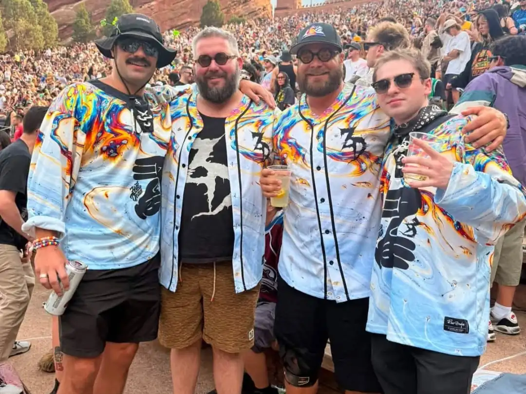 Crew in matching custom light-blue hockey and baseball jerseys at an outdoor concert