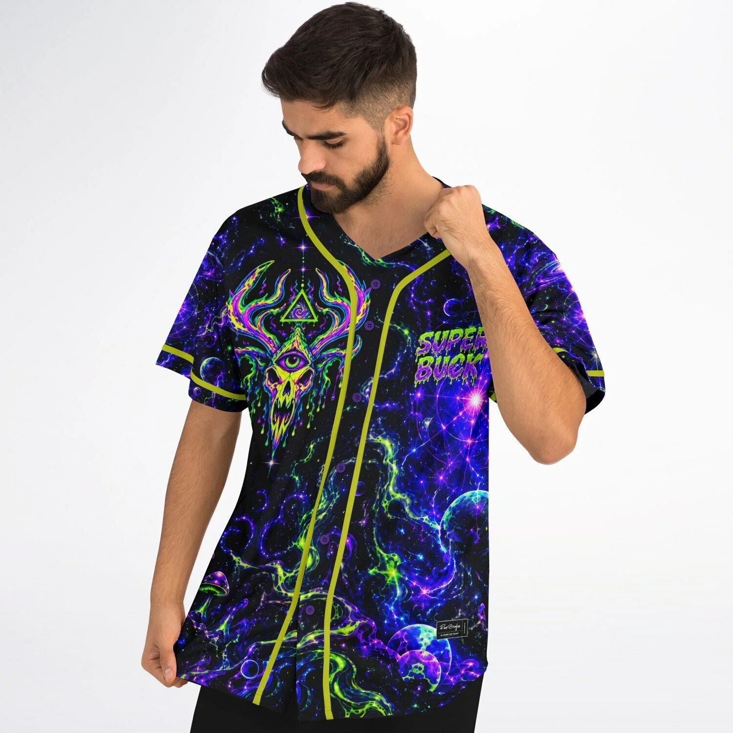 Close-up flat lay of galaxy-themed baseball jersey highlighting neon mushroom, skull, and acid drip lettering details