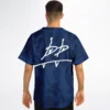 Model wearing navy swirl baseball jersey from behind showing white signature back print