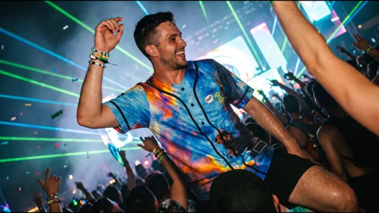 Raver on a friend's shoulders at a night festival wearing an all-over galaxy print sublimated jersey