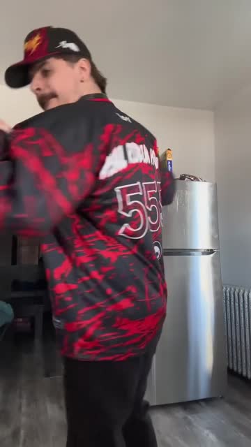 Raver dancing in a rave hockey jersey
